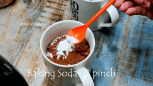 Adding baking soda to chocolate mug cake in air fryer