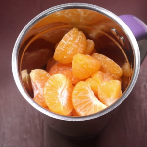 peeled orange in grinding jar