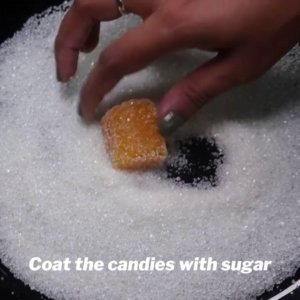 coat orange candy with sugar